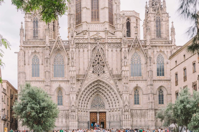 The facade of a Gothic cathedral is visible, with arches, windows, and a large central doorway.