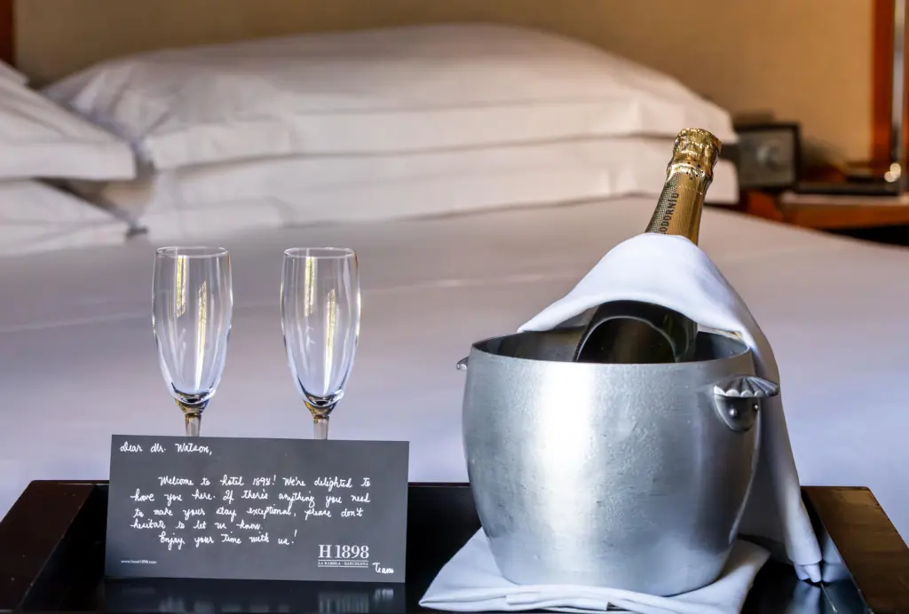An elegant cava bottle with a gold label and black details, presented in a setting that suggests celebration and luxury.