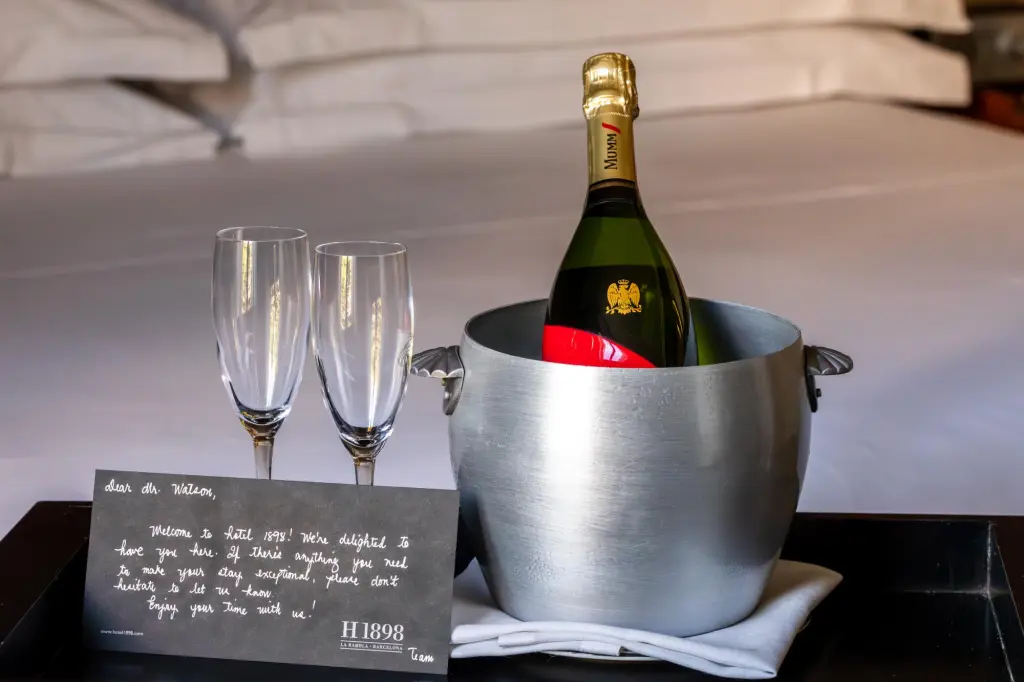 An elegant champagne bottle with a gold label and black details, presented in a setting that highlights its luxury and sophistication.