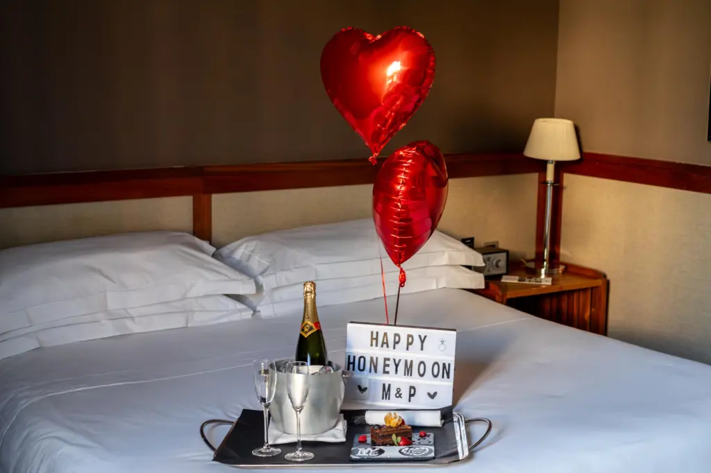 An elegant and inviting room designed for a honeymoon, featuring modern décor and romantic touches that create an intimate, special atmosphere.