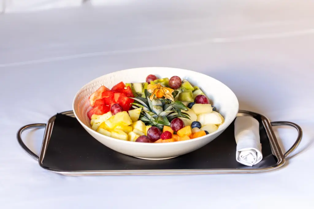 An appealing presentation of freshly sliced fruit, ideal for a healthy breakfast or an in-hotel snack.